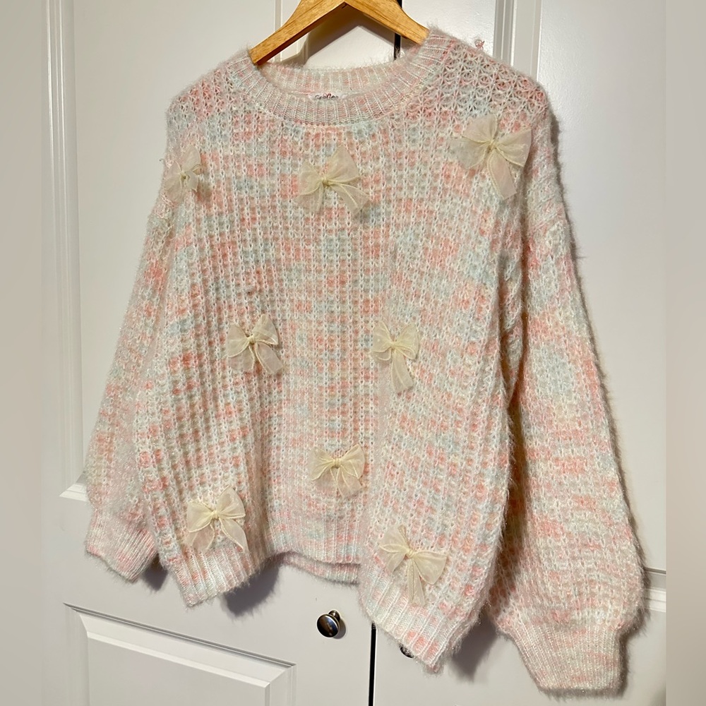 Cozy Cream and Pink Sweater with Bow Accents